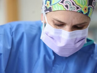 Close-up portrait of a veterinary surgeon wearing surgical scrubs