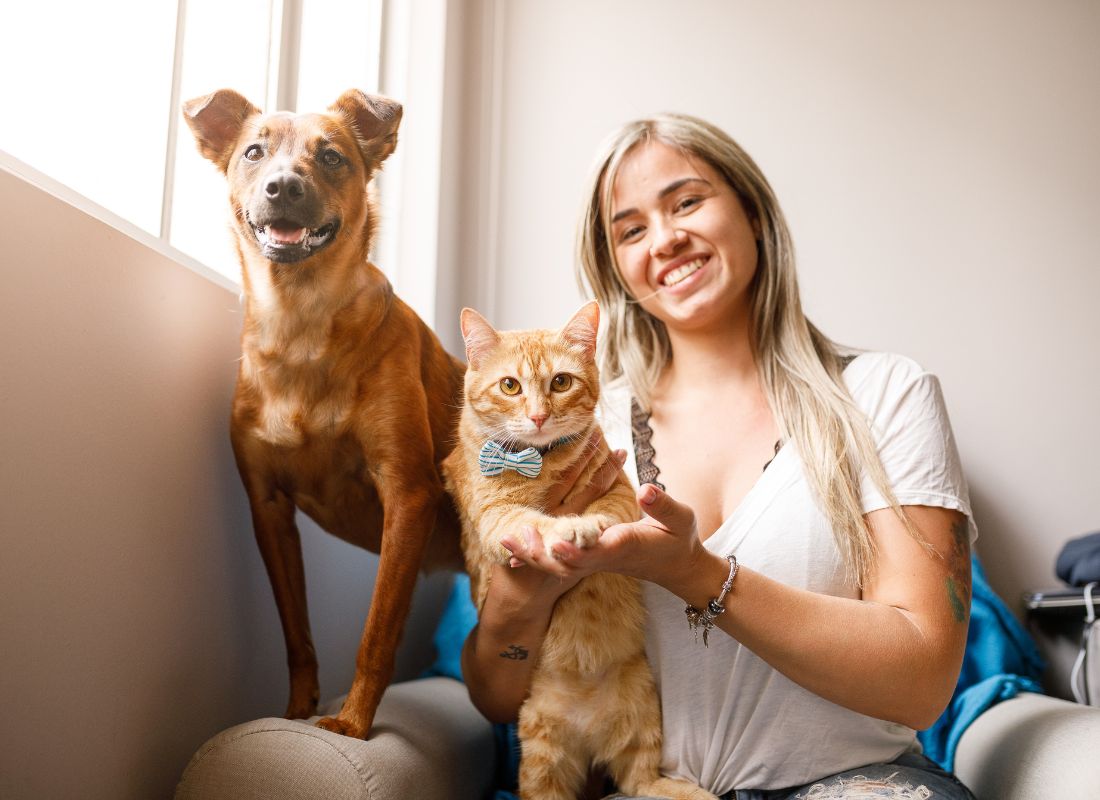 Woman, dog, cat smiling.