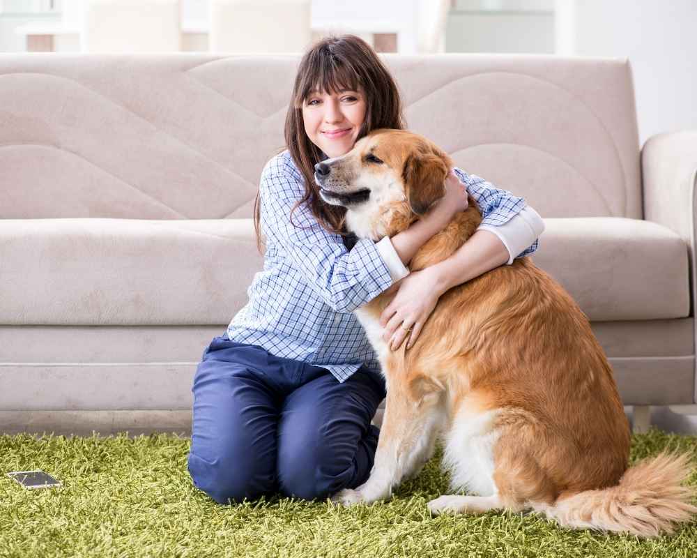 Woman hugging golden retriever.