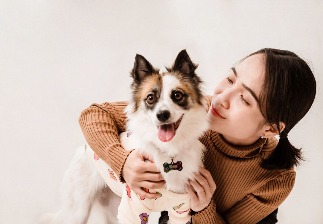 Woman hugging happy dog
